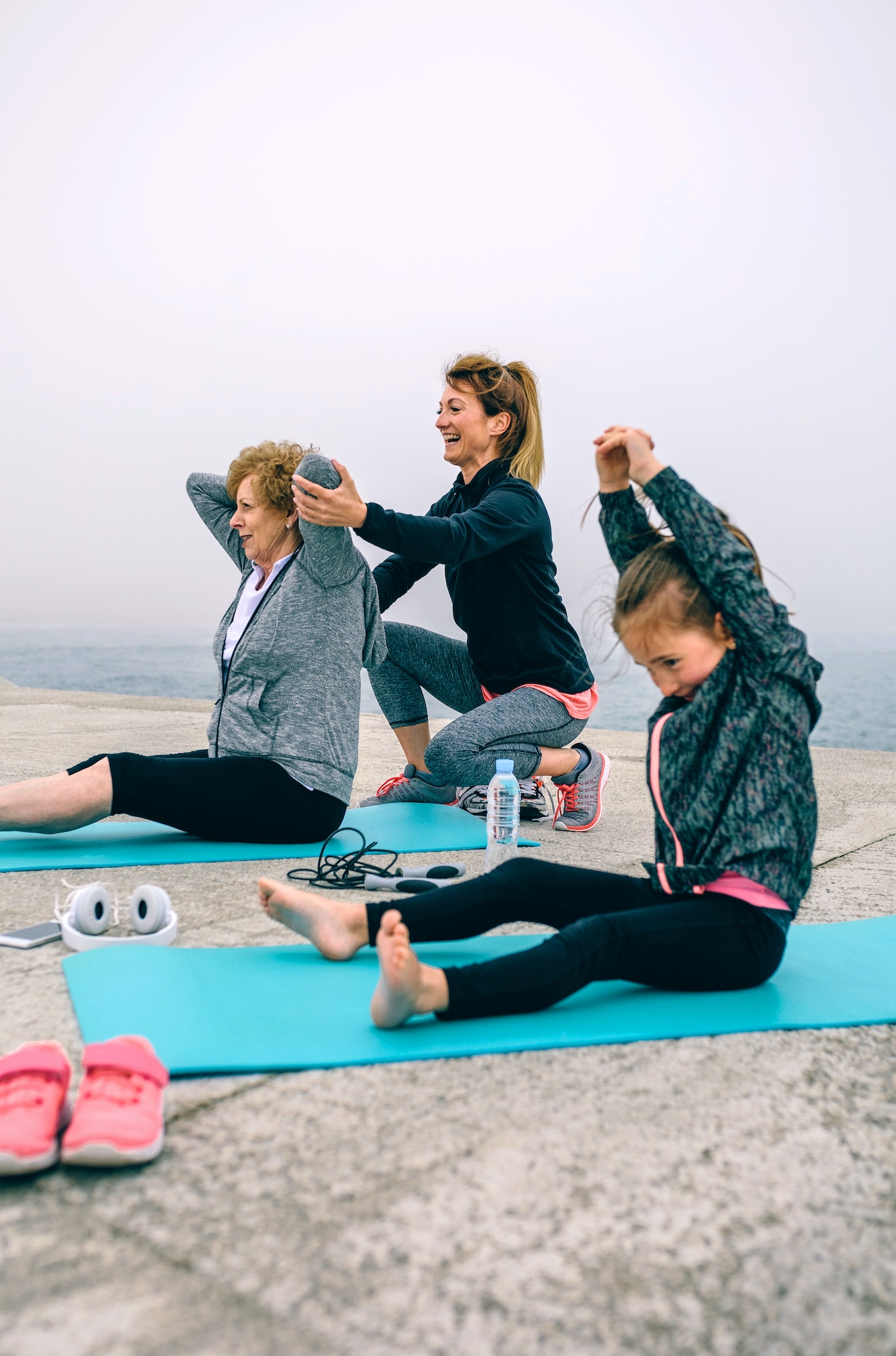Women exercising with little girl